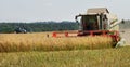 Big combine is working on a field