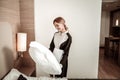 Cheerful hotel maid holding big comfy white pillow