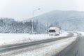 Big commercial semi-trailer truck trapped in snow drift on closed highway road at heavy snow storm blizzard cold winter Royalty Free Stock Photo