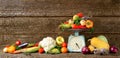 Big composition of fresh autumn vegetables on a wood long banner brown background