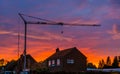 Big construction crane during sunset, building site of a house in the village of Rucphen, Architecture of the netherlands Royalty Free Stock Photo