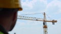 Big construction crane working at construction site outdoor on blue sky background. Huge professional industrial tower Royalty Free Stock Photo