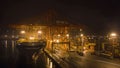 A big container ship is loading cargo in the port