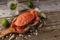 Big cooked king crab served with glass of mojito, lime. ice and seashells on rustic wooden background. Traditional dish islands Royalty Free Stock Photo