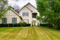 Big country house with a large green lawn in the front yard Royalty Free Stock Photo