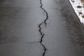 A big crack on the asphalt.Road repairs after winter Royalty Free Stock Photo