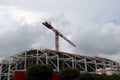 Big crane above the construction of building on cloud and sky background. Royalty Free Stock Photo