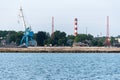 Big crane in dockyard. Large iron navy ships in shipyard for repair. Blue sea harbor