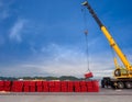 Stacking of steel pipe in bundles by big crane. Royalty Free Stock Photo