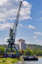 Big crane unloading coal from barge to train wagon Royalty Free Stock Photo