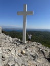 Big cross against the background of the sea. A man near the Christian monument Cross of Jesus.