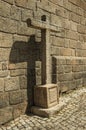 Big cross carved on stone beside church wall in Monsanto Royalty Free Stock Photo