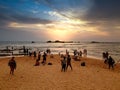 Big crowd looking on the sunset at ocean beach on tropical island