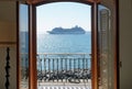 Big cruise liner in the open mediteranean sea at sunny day. View through the open door of the balcony. Royalty Free Stock Photo