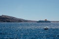 Big cruise ship and boat in Aegean sea taken from the land of island of Santorini, Greece. Royalty Free Stock Photo