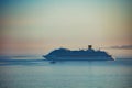 Big cruise ship seascape eclipses the foggy horizon at sunset Royalty Free Stock Photo