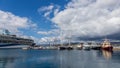 Big cruise ship and smaller ships in harbor Palamos in Spain, Tu