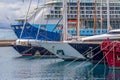 Big cruise ship and smaller ships in harbor Palamos in Spain, Tu