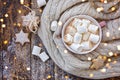 Big cup of cappuccino with marshmallo and christmas cookies on brown wooden background with christmas lights. Royalty Free Stock Photo