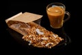 Big cup of coffe and scattered from open craft bag granola Royalty Free Stock Photo