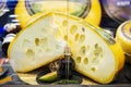 Big cut head of cheese close up on showcase on counter at store, real scene in food market Royalty Free Stock Photo