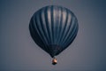 Big dark blue balloon in the sky. Aerostat. People in the basket. Fun. Summer entertainment. Romantic adventures Royalty Free Stock Photo