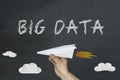 Big data concept drawn on blackboard with hand holding paper airplane Royalty Free Stock Photo