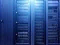 Data Center Computer Cabinet Background. Technologies background. Big data dark server room with bright blue equipment Royalty Free Stock Photo