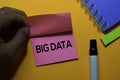 Big Data write on sticky notes. Isolated on orange table background Royalty Free Stock Photo