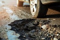 big deep pothole and car tire on the road Royalty Free Stock Photo