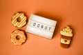 Big donut and Gingerbread coffee on orange background birthday decoration