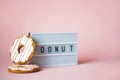 Big donut and Gingerbread donut on pink background birthday decoration