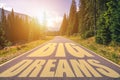 Big dreams written on road in the mountains. Big dreams text on the road