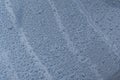 Big drops of rain on a car bonnet, the texture of paint is blue metallic Royalty Free Stock Photo