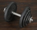 Big dumbbell on rustic background