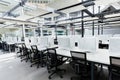 Big empty rental office for IT workers with wrapped in cover computers