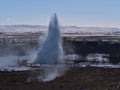 Big eruption of famous geyser Strokkur located in Geysir in geothermal area Haukadalur Iceland in winter. Royalty Free Stock Photo