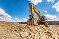 Big excavator moving earth in the construction works of a road