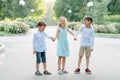 Big family. Brothers and sisters. Children are walking in the park. A group of three children in a summer forest.