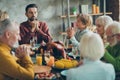 Big family celebrate thanksgiving day sit table have large feast meal food roasted meat corns alcohol pray in house