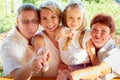 Big family with child playing in a park. Women, man and girl relax in the garden. Mother, father, grandmother and Royalty Free Stock Photo