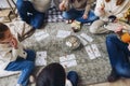 Big family with children sitting on floor near Xmas tree playing lotto board game together Royalty Free Stock Photo