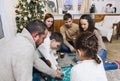 Big family with children sitting on floor playing board game at home Royalty Free Stock Photo