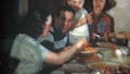 1951: Big family at crowded dinner table eat Italian food. NEWARK, NEW JERSEY