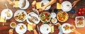 Big family dinner in process. Top view vertical image on table w