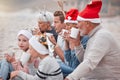 Big family, drinking cocoa and relaxing for Christmas holiday, bonding and quality time together in the outdoors Royalty Free Stock Photo