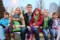 Big family in evening sitting on the bench. Royalty Free Stock Photo