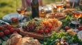 Big family garden party. Glasses of wine, large plates and bowls with vegetables, fruits, berries, greenery and bread on Royalty Free Stock Photo