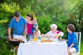 Big family grilling meat for lunch Royalty Free Stock Photo