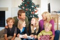 Big family, happy and gift for christmas in living room of home for celebration, holiday or present. Parents, children Royalty Free Stock Photo